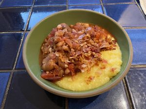 Bowl of polenta with tomato and beans