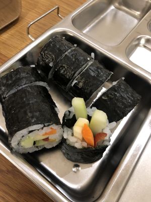 Sushi rolls in a metal lunch box