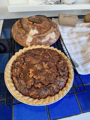 Pie and a loaf of bread cooling