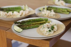 Plates of shrimp tacos & asparagus