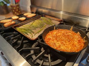 Tomato-bean bake, asparagus, and grilled bread on the range