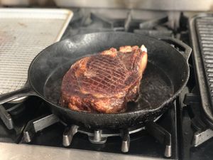 Steak cooking in a pan