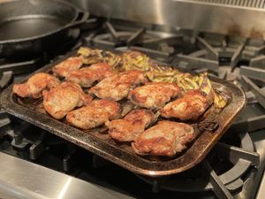 Broiled chicken and artichokes on a grill pan