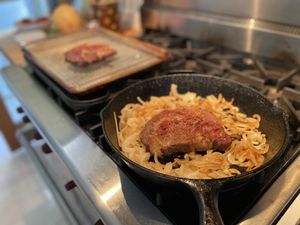 Steak with onions in a pan