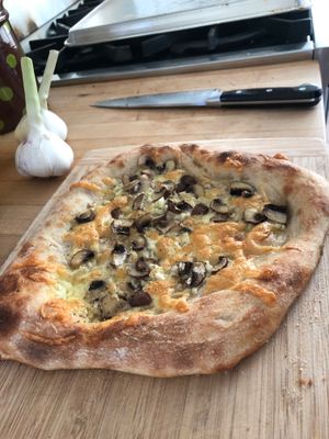 Mushroom pizza on a cutting board