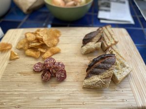 Grilled bread and sliced salami chunks