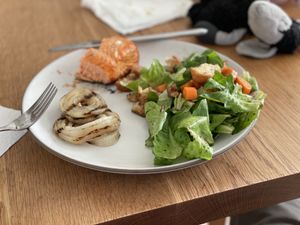 Plate with salmon, BBQ onions, and green salad