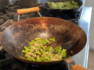 Green garlic and onions in a wok