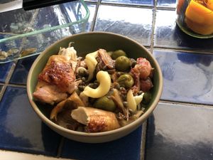 Chicken Marbella served with pasta in a bowl