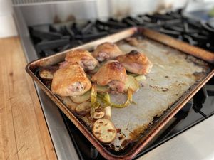 Chicken and green onions on a sheet pan