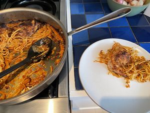 Pan and a plate both with pasta