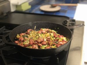 Meat cooking in a cast iron skillet