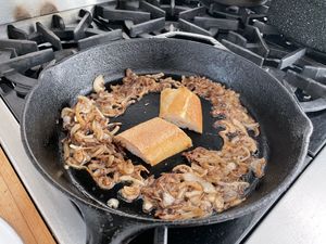 Bread and onion in a skillet