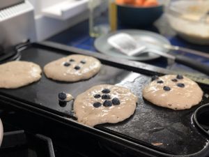 Blueberry pancakes on a griddle
