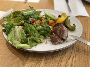 Sausage roasted with peppers and a green salad on the side