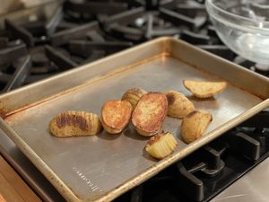 Hasselback potatoes on a baking sheet