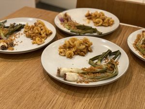 Spring onions and pasta on plates
